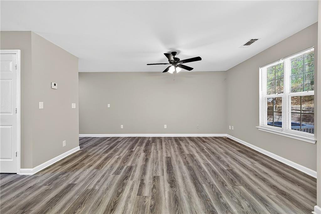 1065 Maple Valley Court Union City, GA 30291 - Photo 10 of 29 wooden floor in an empty room with a window
