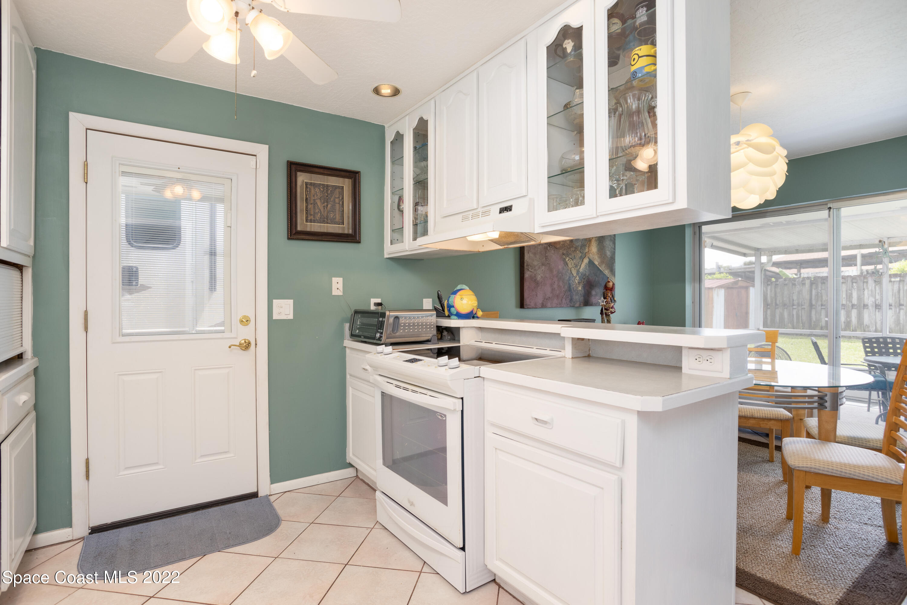 947 Brunswick Lane Rockledge, FL 32955 - Photo 11 of 22 a kitchen with cabinets appliances and a window