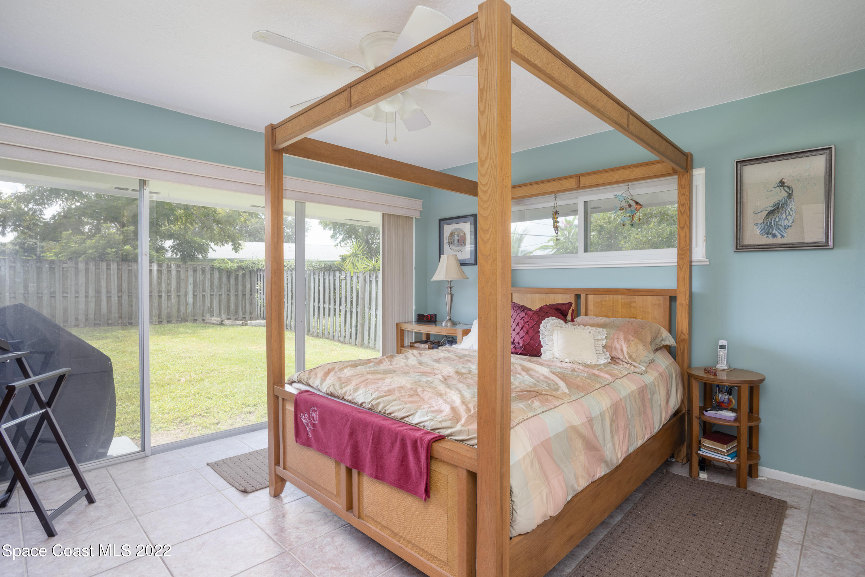 947 Brunswick Lane Rockledge, FL 32955 - Photo 12 of 22 a bed sitting in a bedroom next to a window