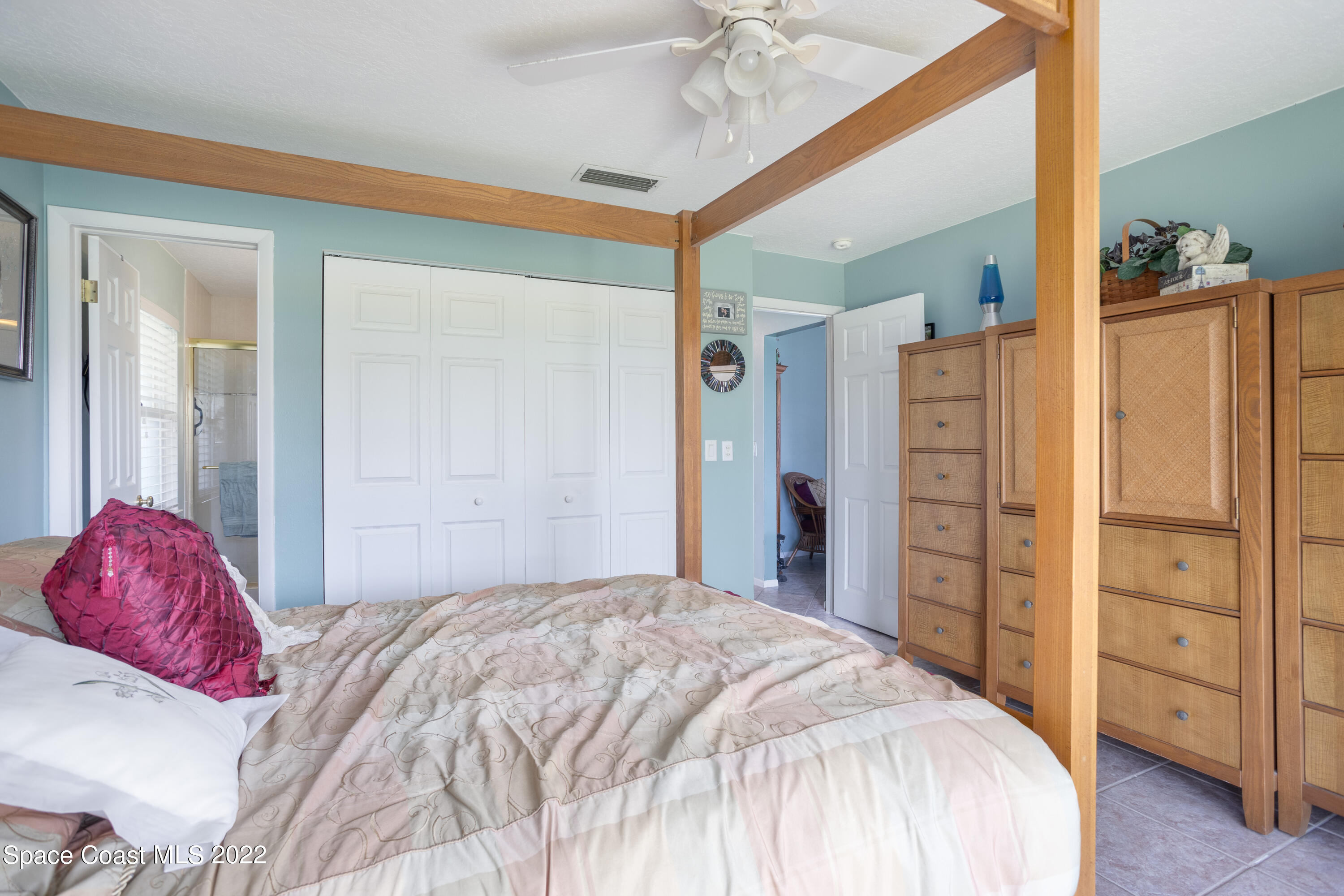 947 Brunswick Lane Rockledge, FL 32955 - Photo 13 of 22 a bedroom with a bed and a dresser
