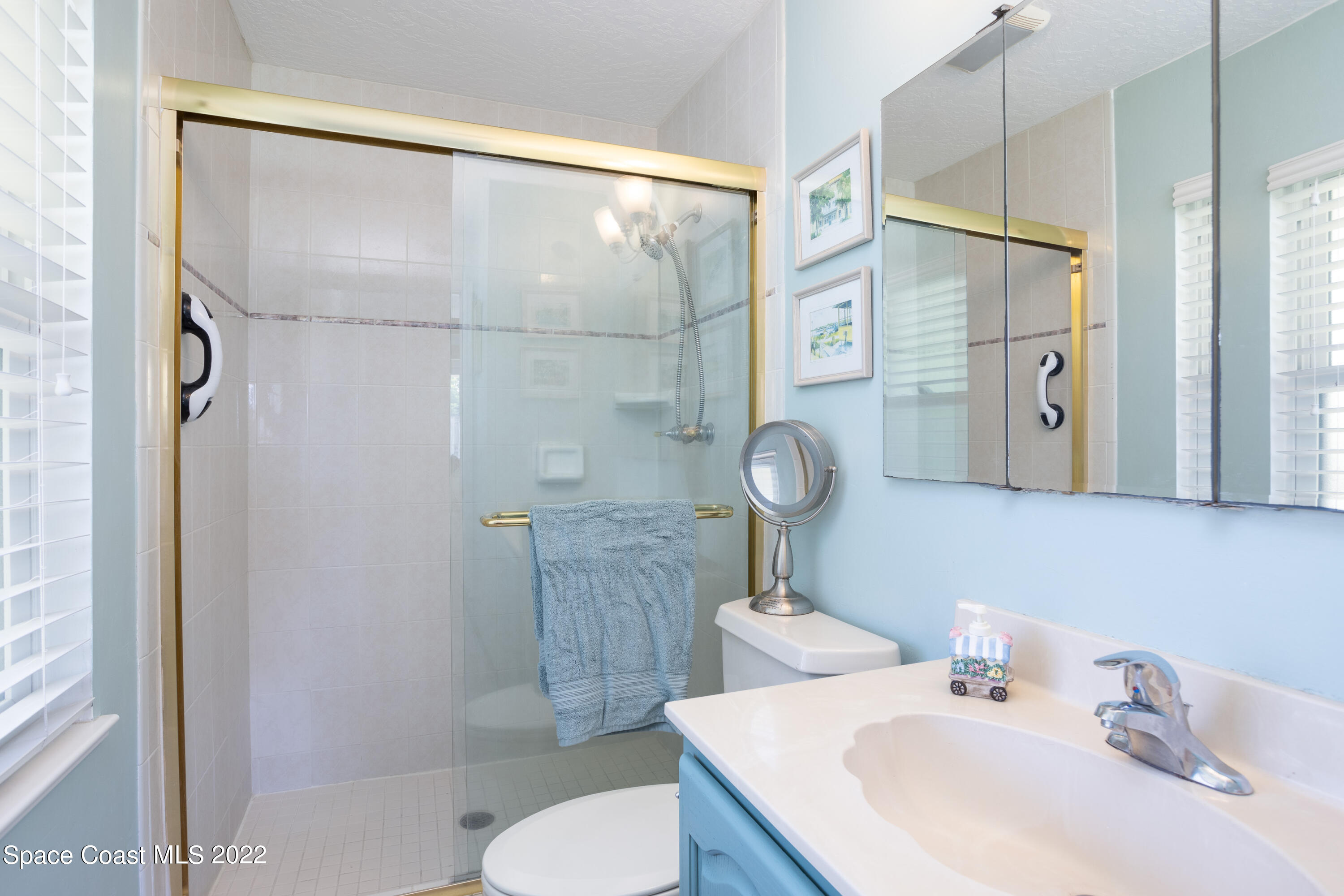 947 Brunswick Lane Rockledge, FL 32955 - Photo 14 of 22 a bathroom with a sink a toilet and shower