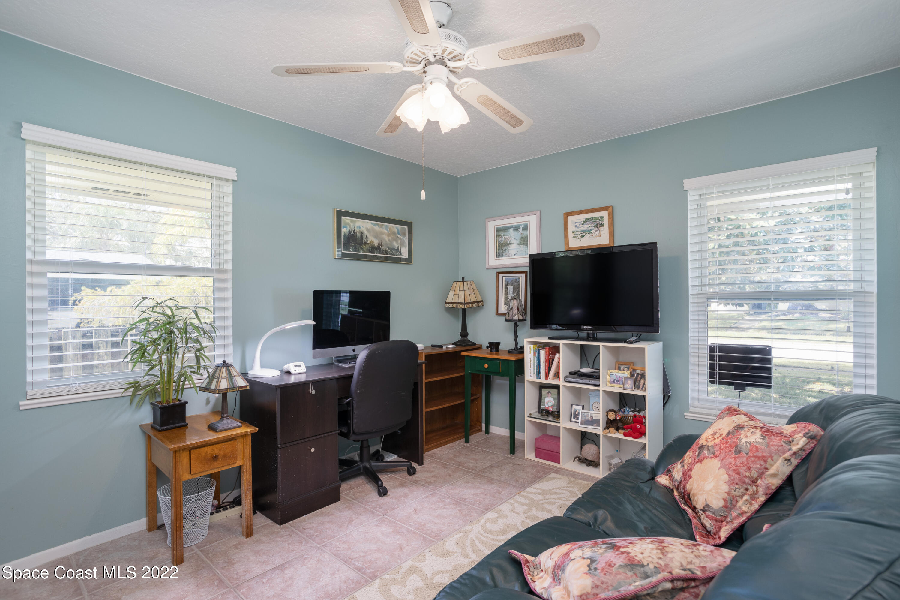 947 Brunswick Lane Rockledge, FL 32955 - Photo 15 of 22 a livingroom with workspace window and a flat screen television