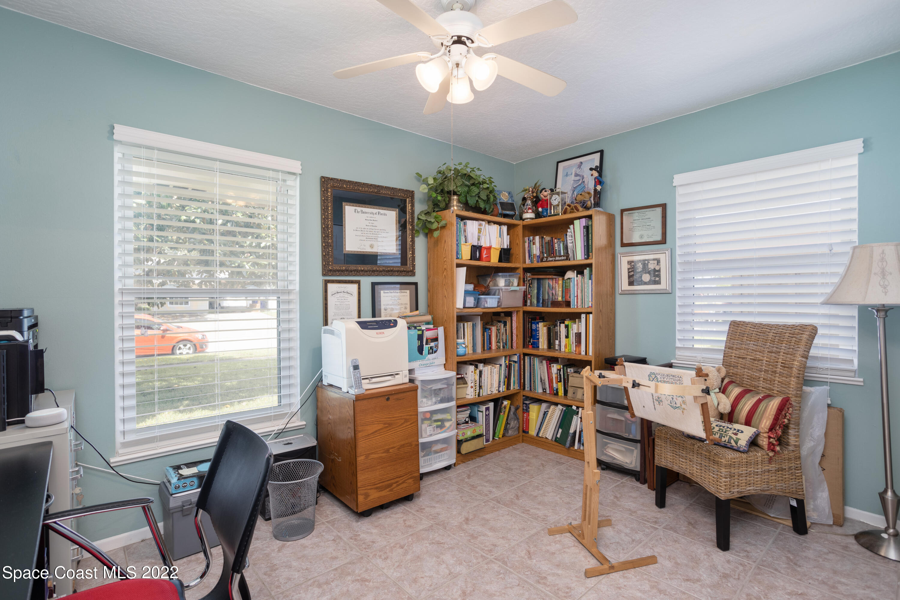 947 Brunswick Lane Rockledge, FL 32955 - Photo 16 of 22 a living room with furniture and a book shelf