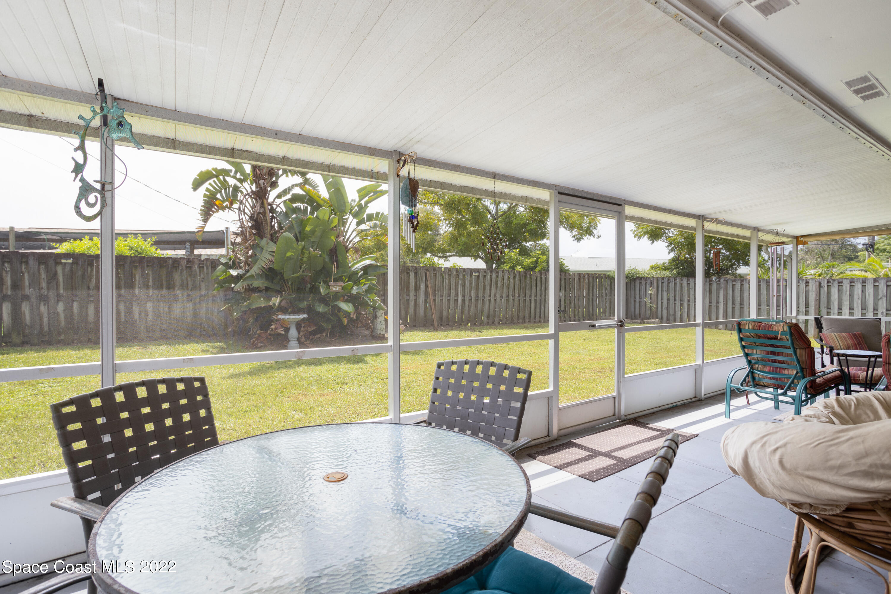 947 Brunswick Lane Rockledge, FL 32955 - Photo 20 of 22 a living room with a large window and dining table