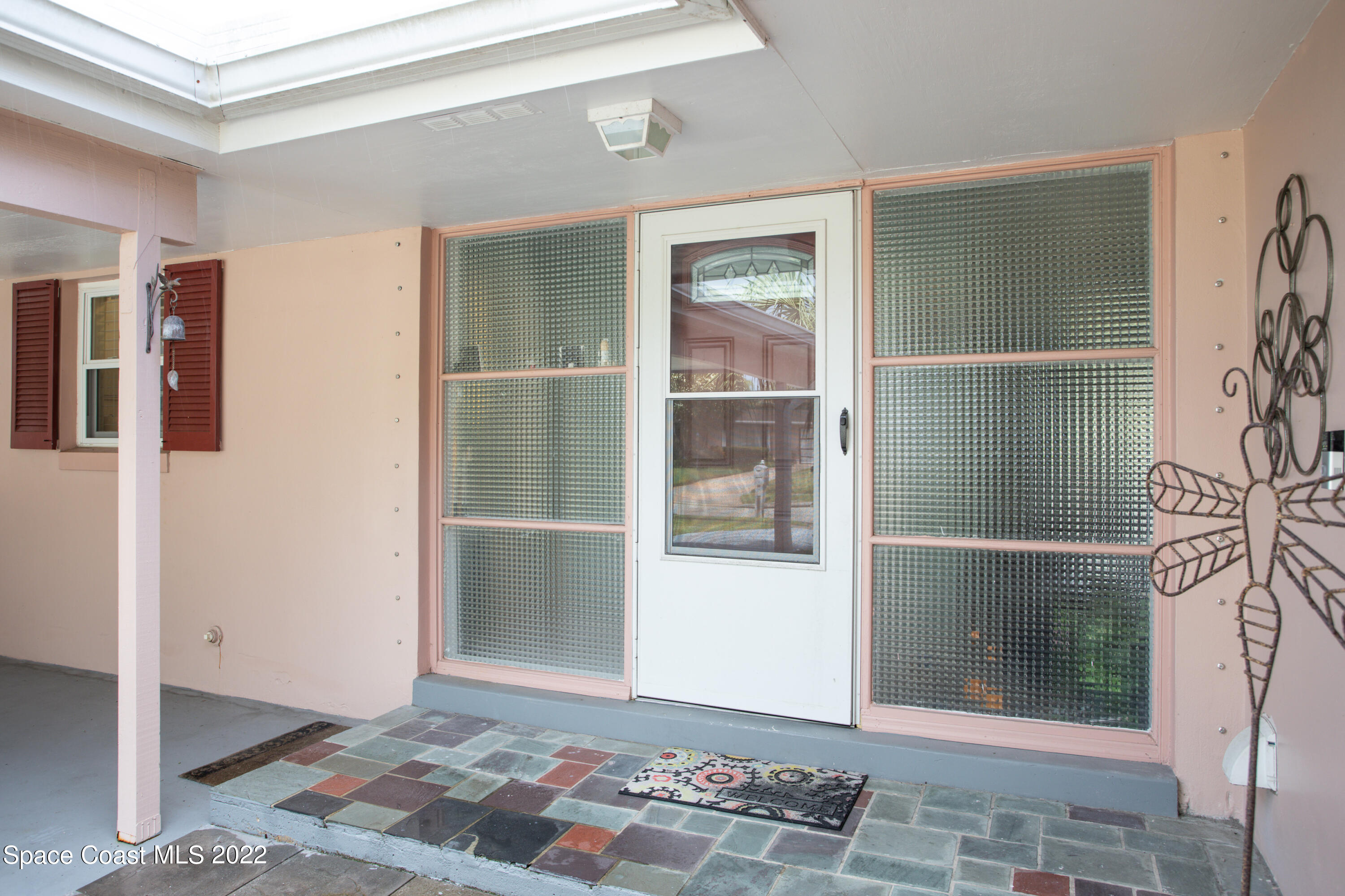 947 Brunswick Lane Rockledge, FL 32955 - Photo 4 of 22 a view of an empty room with wooden floor and a window