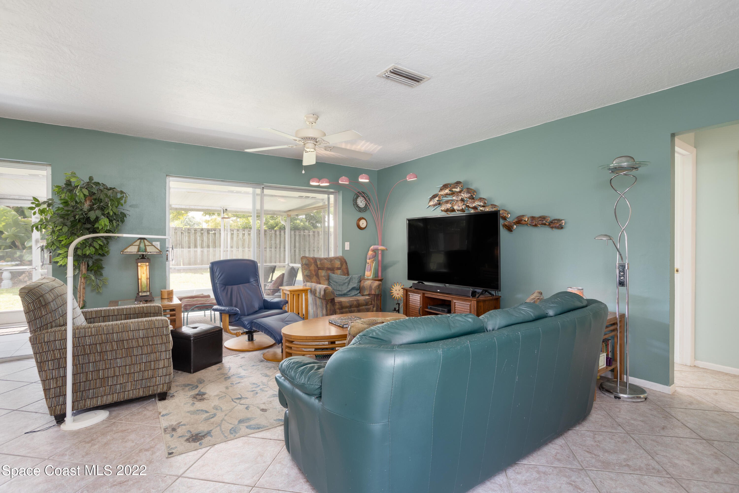 947 Brunswick Lane Rockledge, FL 32955 - Photo 7 of 22 a living room with furniture and a flat screen tv
