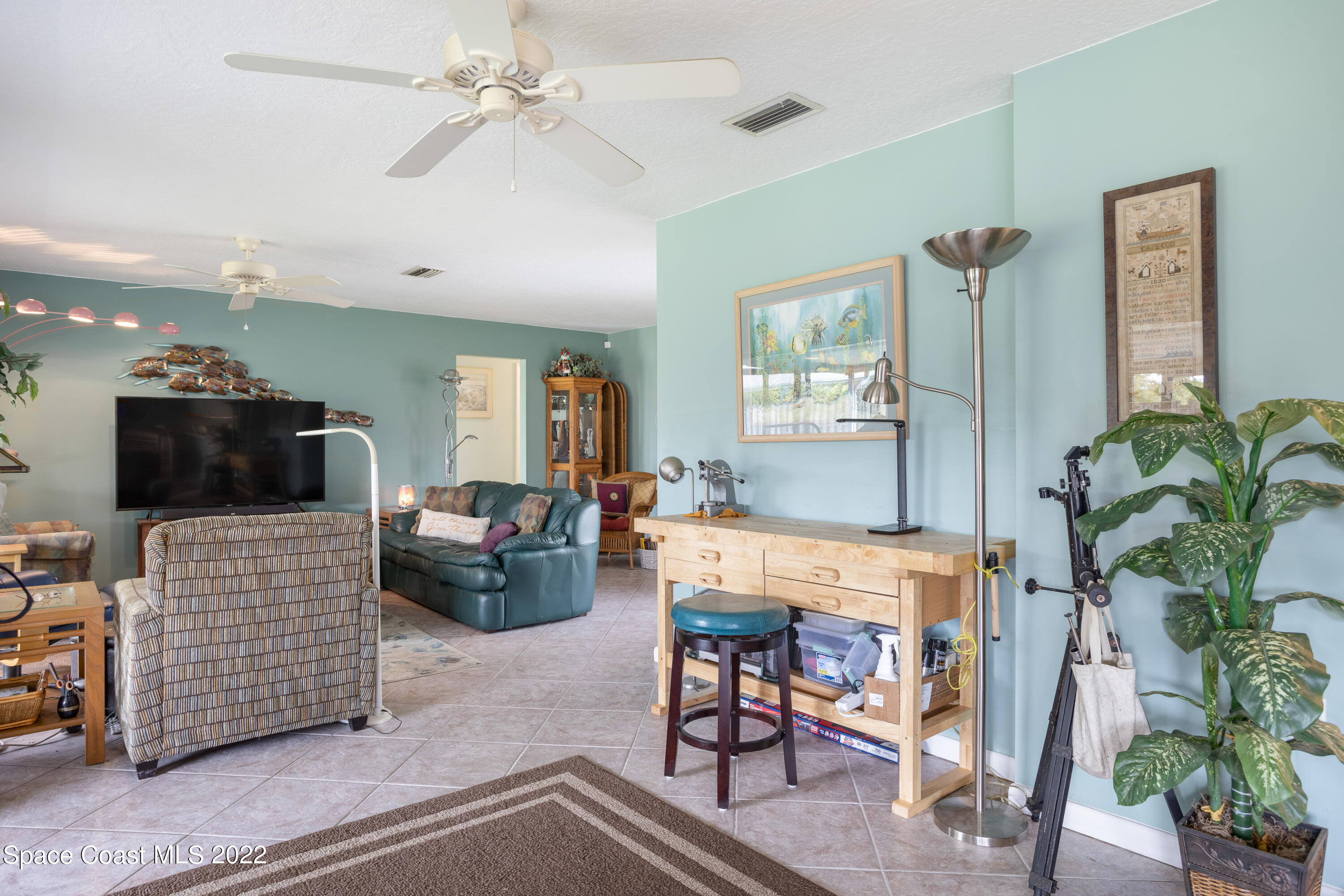 947 Brunswick Lane Rockledge, FL 32955 - Photo 8 of 22 a living room with furniture and a flat screen tv