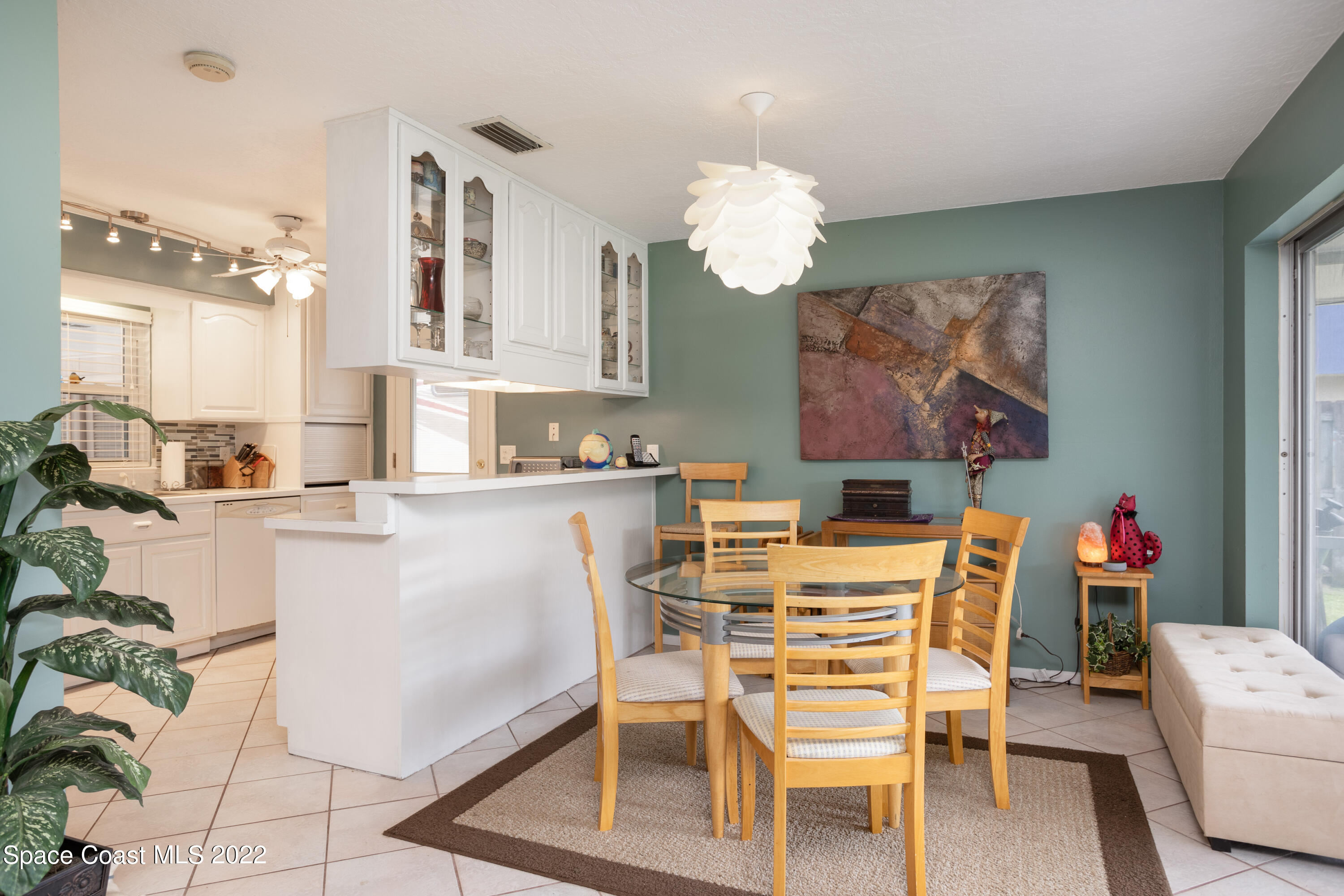 947 Brunswick Lane Rockledge, FL 32955 - Photo 9 of 22 a dining room filled chandelier and kitchen view