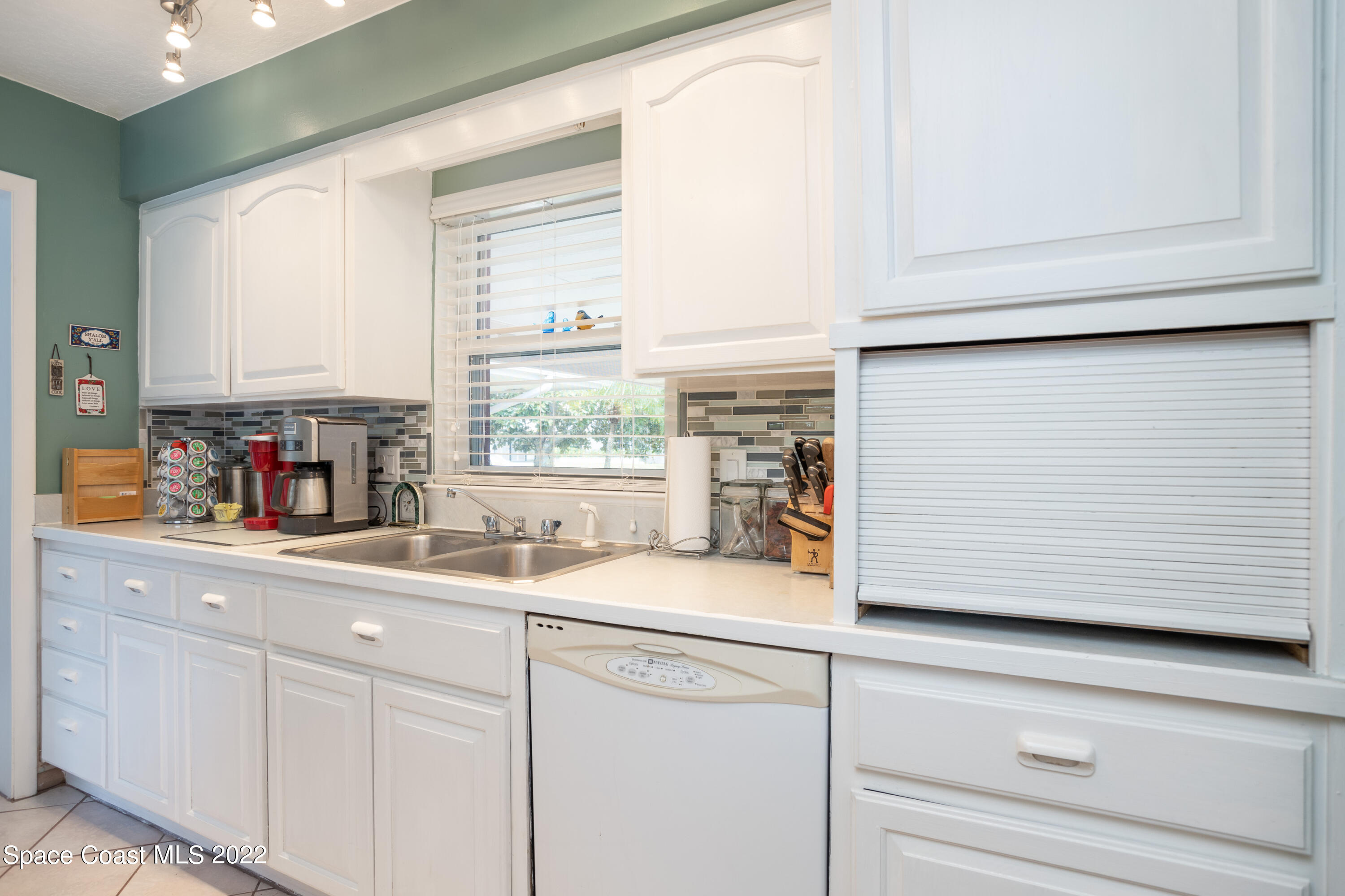 947 Brunswick Lane Rockledge, FL 32955 - Photo 10 of 22 a kitchen with appliances cabinets and a window