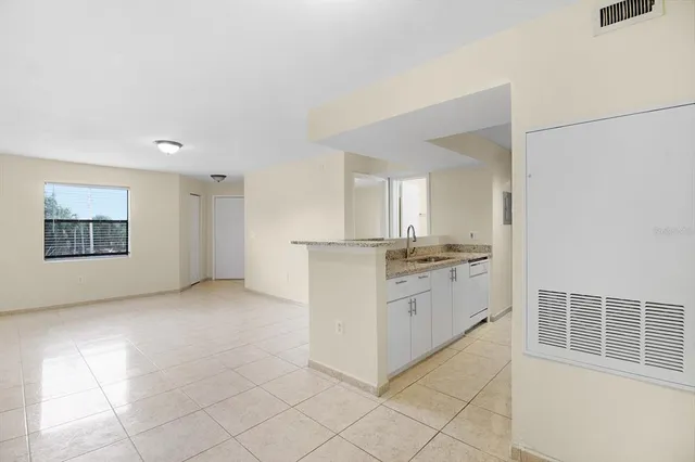 a kitchen with a refrigerator and a sink