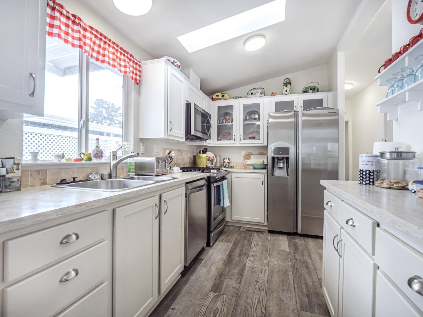 100 North Rodeo Gulch Road, Unit 65 Soquel, CA 95073 - Photo 11 of 24 a kitchen with a sink window and refrigerator