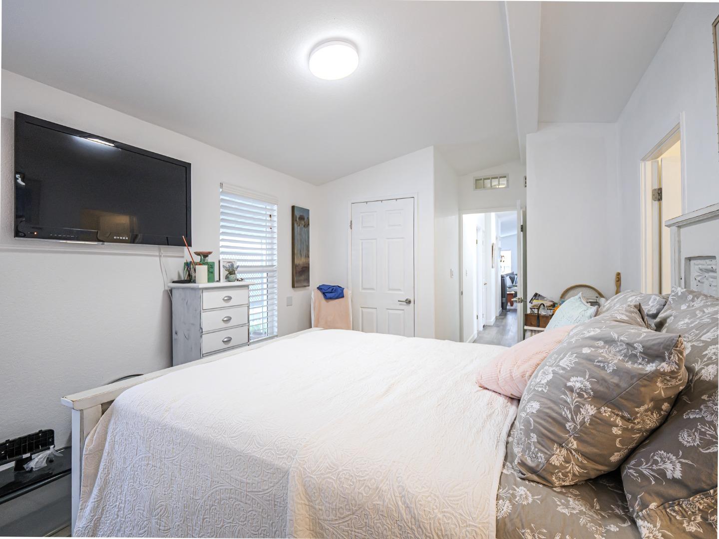 100 North Rodeo Gulch Road, Unit 65 Soquel, CA 95073 - Photo 15 of 24 a bedroom with a bed and a flat screen tv