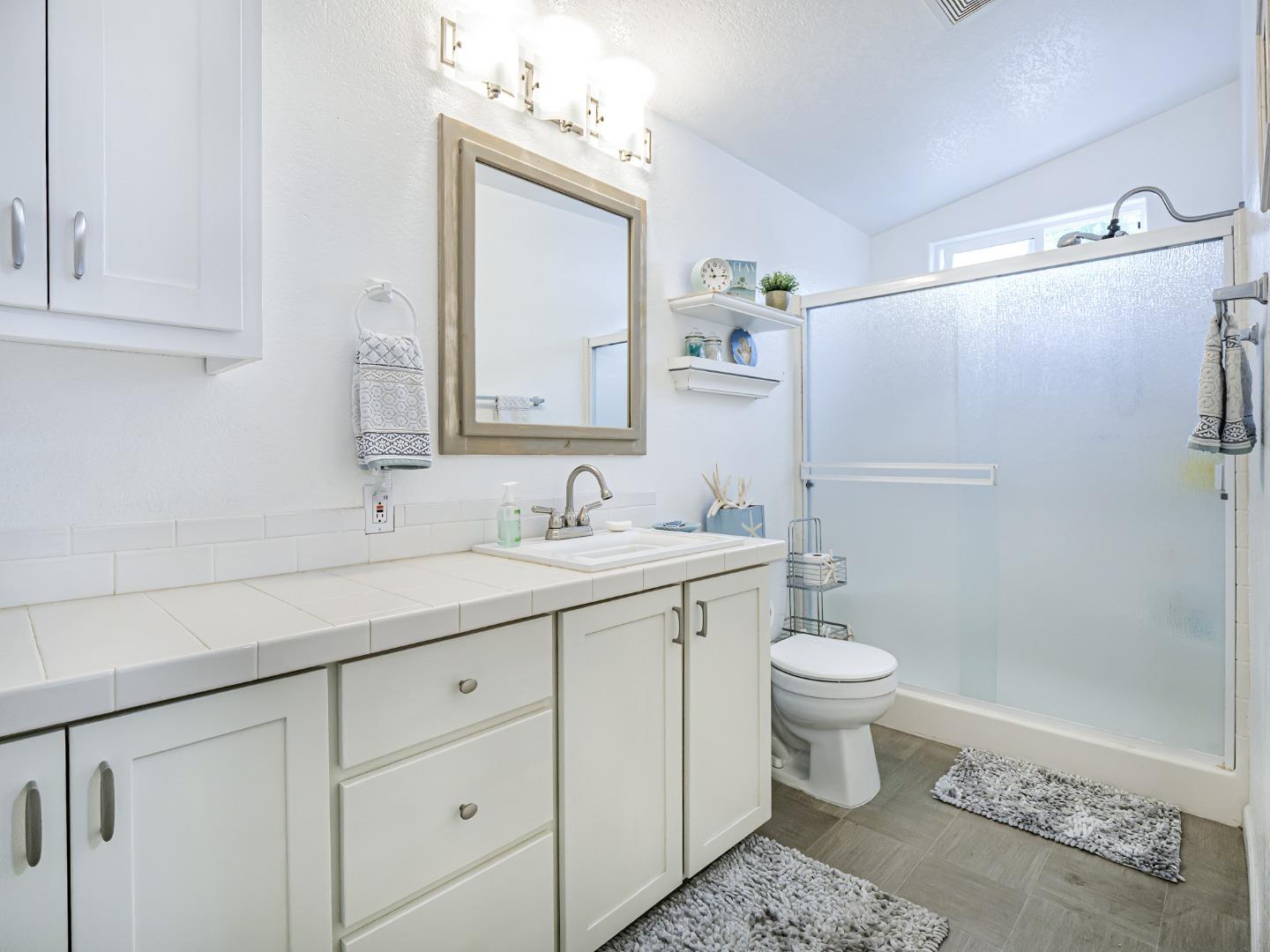 100 North Rodeo Gulch Road, Unit 65 Soquel, CA 95073 - Photo 16 of 24 a bathroom with a sink a toilet and shower