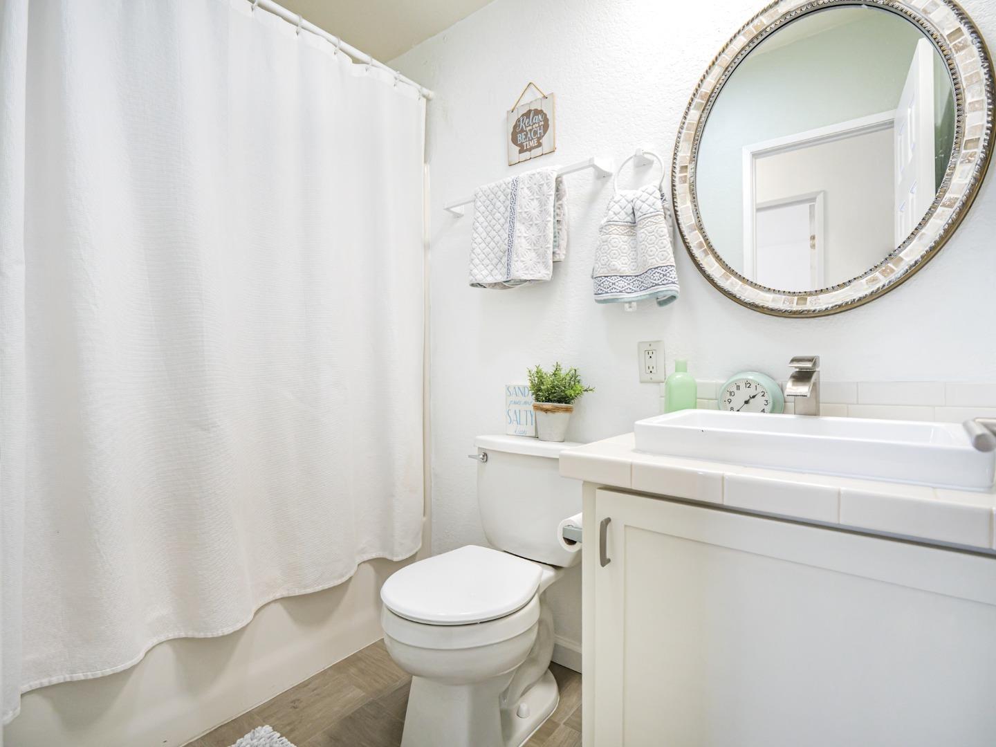 100 North Rodeo Gulch Road, Unit 65 Soquel, CA 95073 - Photo 18 of 24 a bathroom with a sink vanity mirror and toilet