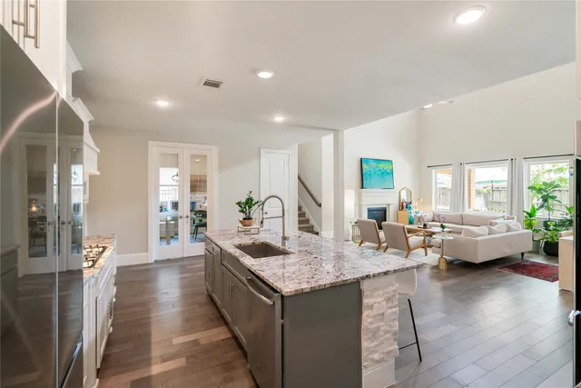 a large living room with stainless steel appliances granite countertop a couch and a couch