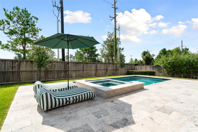 a view of backyard with swimming pool and outdoor seating