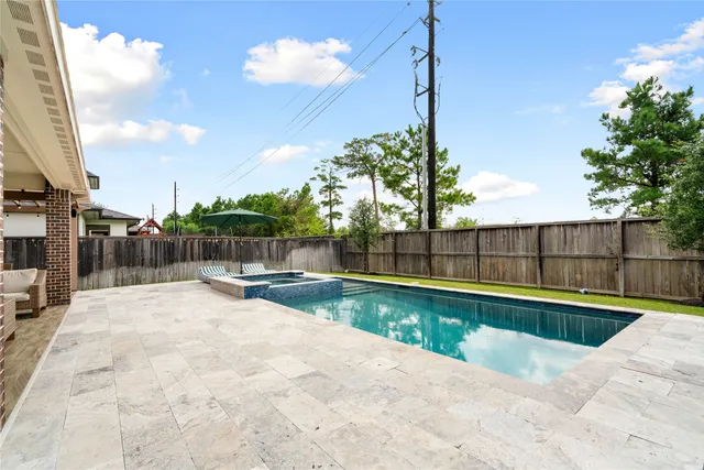 a view of swimming pool with a patio and city view