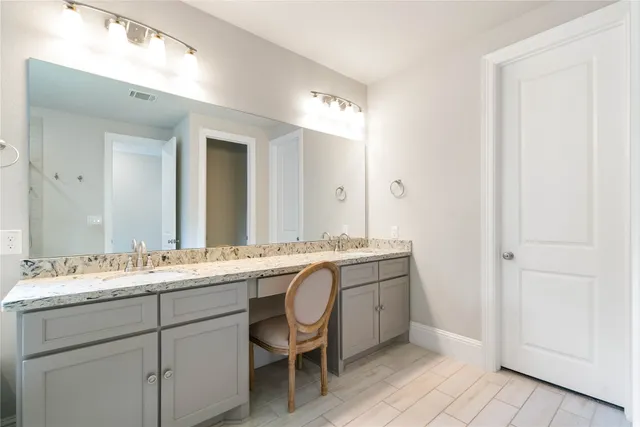 a bathroom with a double vanity sink and a mirror