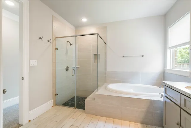 a bathroom with a bathtub and a shower