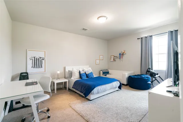 a bedroom with a bed and a couch