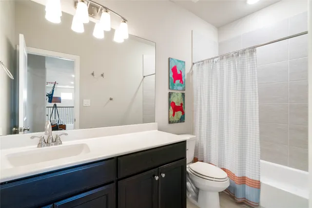 a bathroom with a sink toilet and a mirror