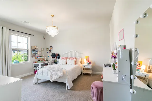 a bedroom with bed and window