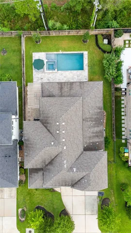 an aerial view of a house with a garden and a yard