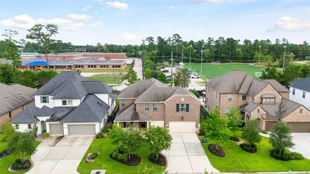 an aerial view of a house with a garden and trees