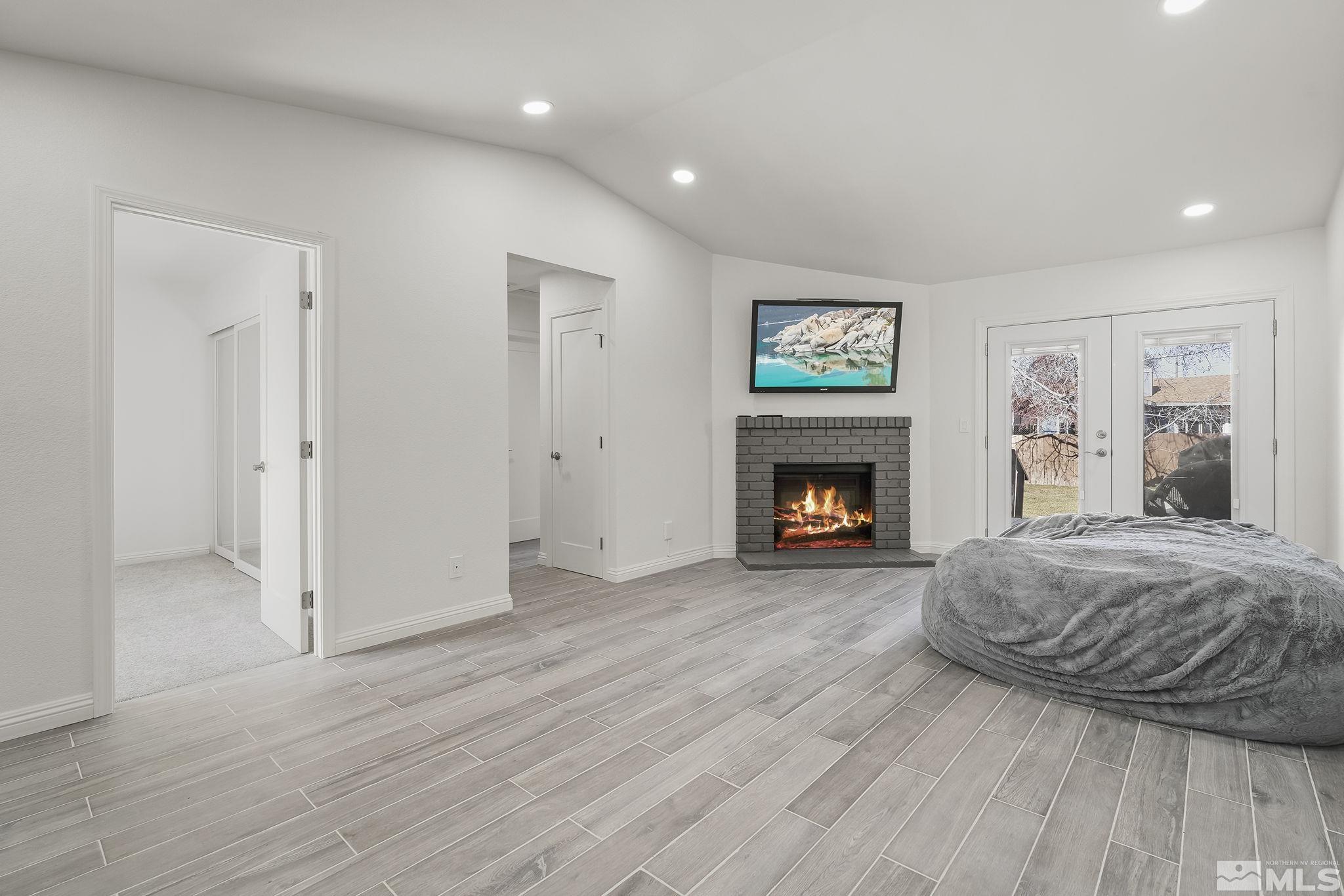 10029 Humite Lane Reno, NV 89506 - Photo 3 of 15 a spacious bedroom with a bed and a fireplace