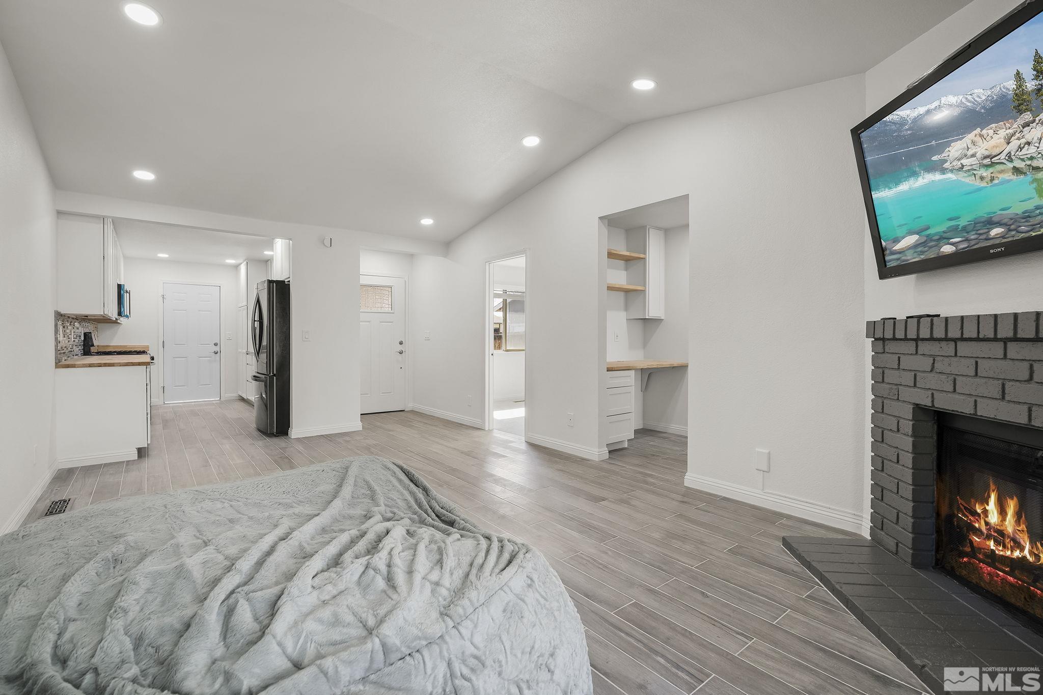 10029 Humite Lane Reno, NV 89506 - Photo 5 of 15 a view of empty room with wooden floor and fireplace
