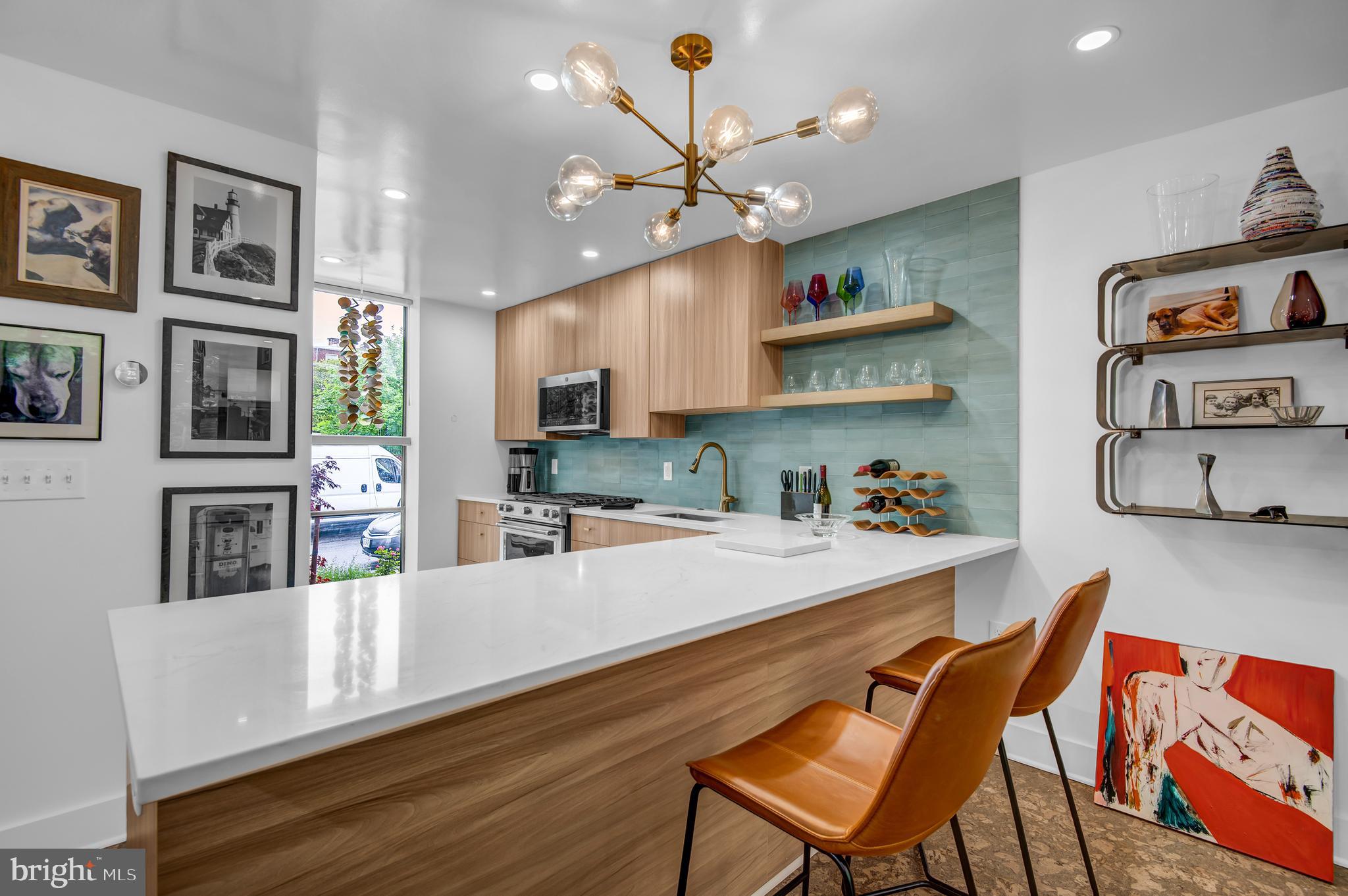 a living room with stainless steel appliances kitchen island a table and chairs