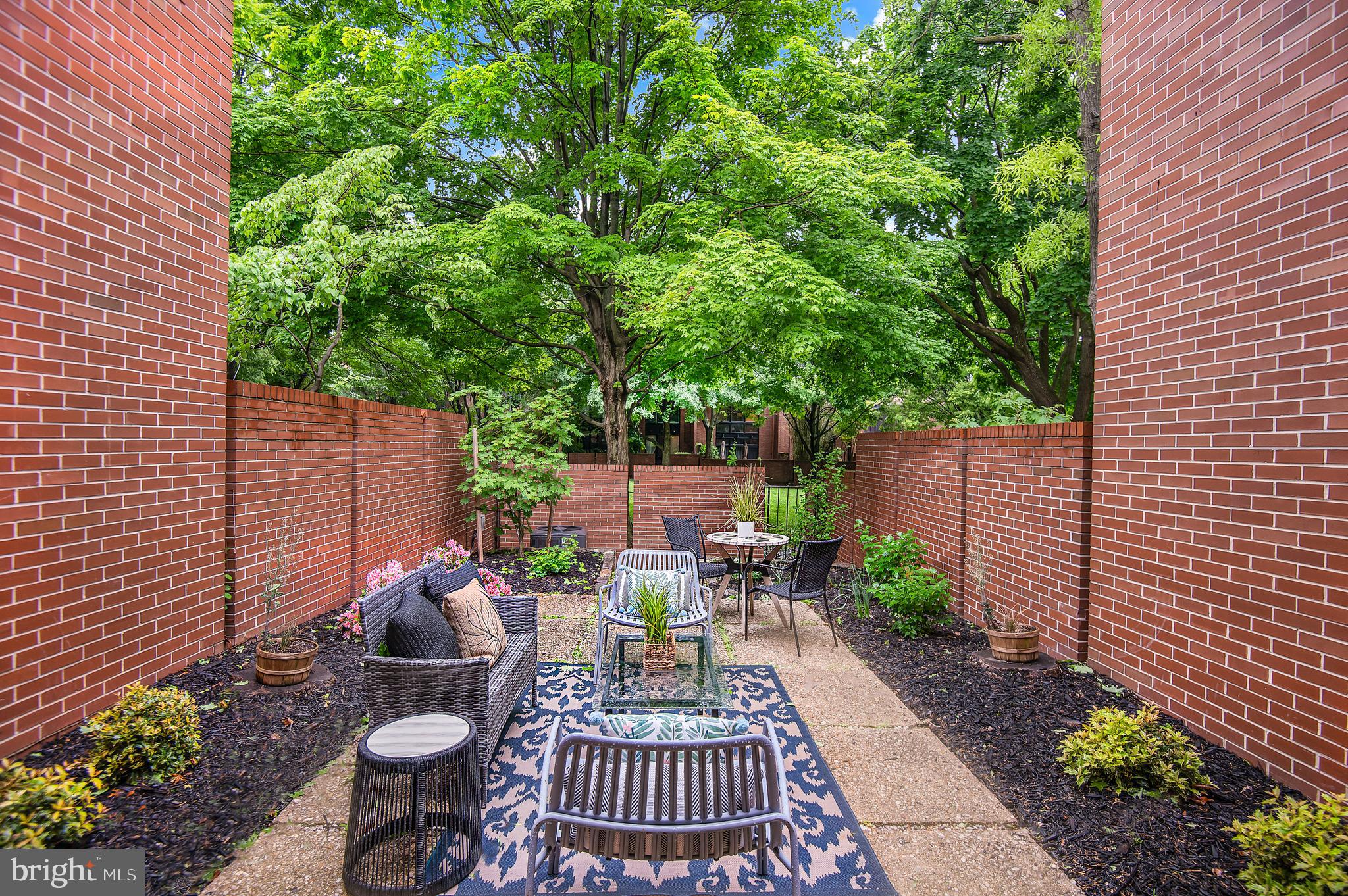 1410 Mason Street Baltimore, MD 21217 - Photo 13 of 24 a view of a patio with table and chairs potted plants and large tree