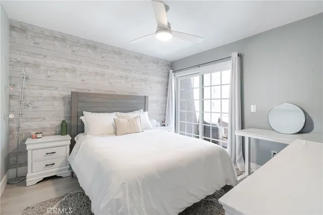 a bedroom with a bed and a large window