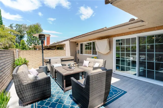 a view of a patio with couches table and chairs and potted plants