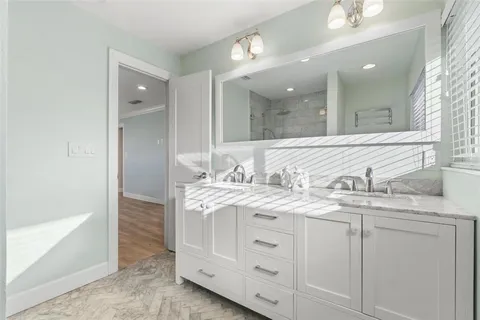 a bathroom with a granite countertop sink a toilet and a mirror