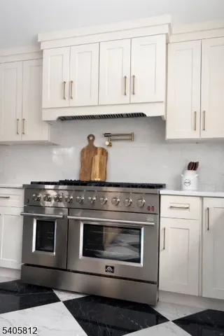 a stove top oven sitting inside of a kitchen