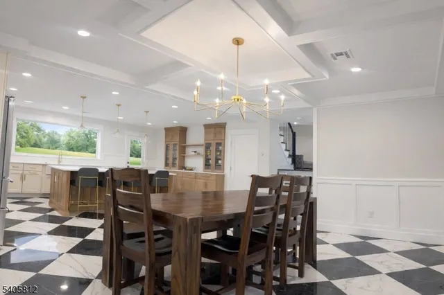 a view of a dining room and livingroom with furniture and window
