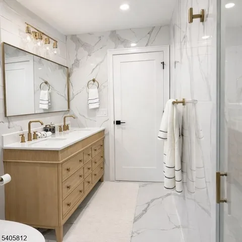 a bathroom with a double vanity sink mirror and shower
