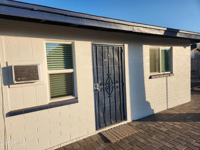 a view of a house with a wooden deck