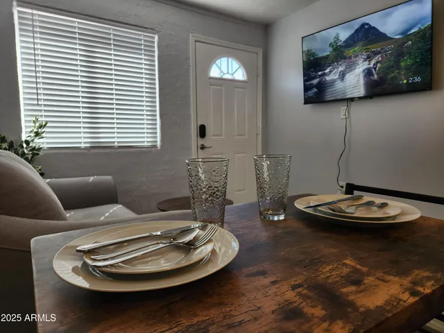 a dining room with furniture and window