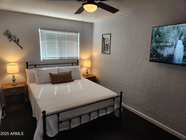 a bed sitting in a bedroom next to a window