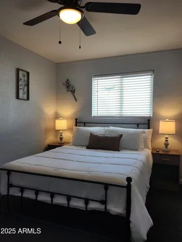 a bedroom with a bed and a lamp