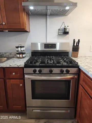 a stove top oven sitting inside of a kitchen
