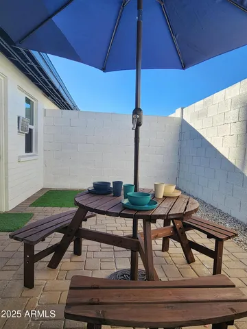 a table and chairs in the balcony