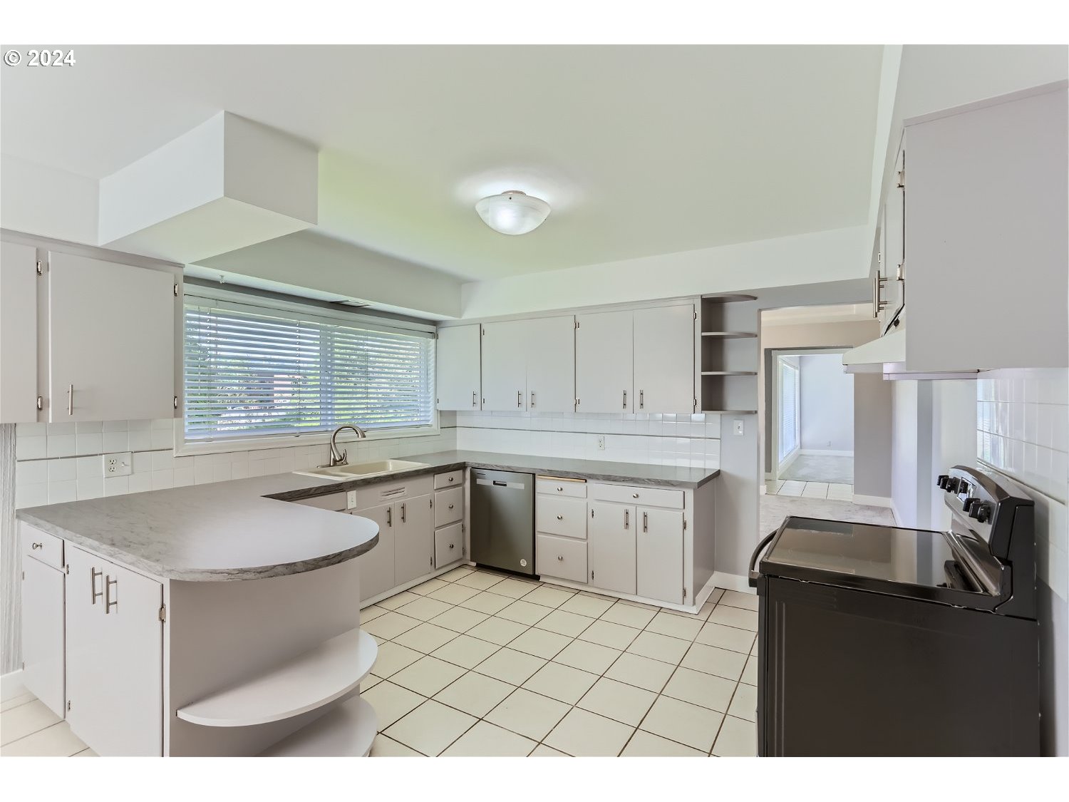 9386 Southwest 35th Avenue Portland, OR 97219 - Photo 11 of 29 a kitchen with a sink cabinets and window