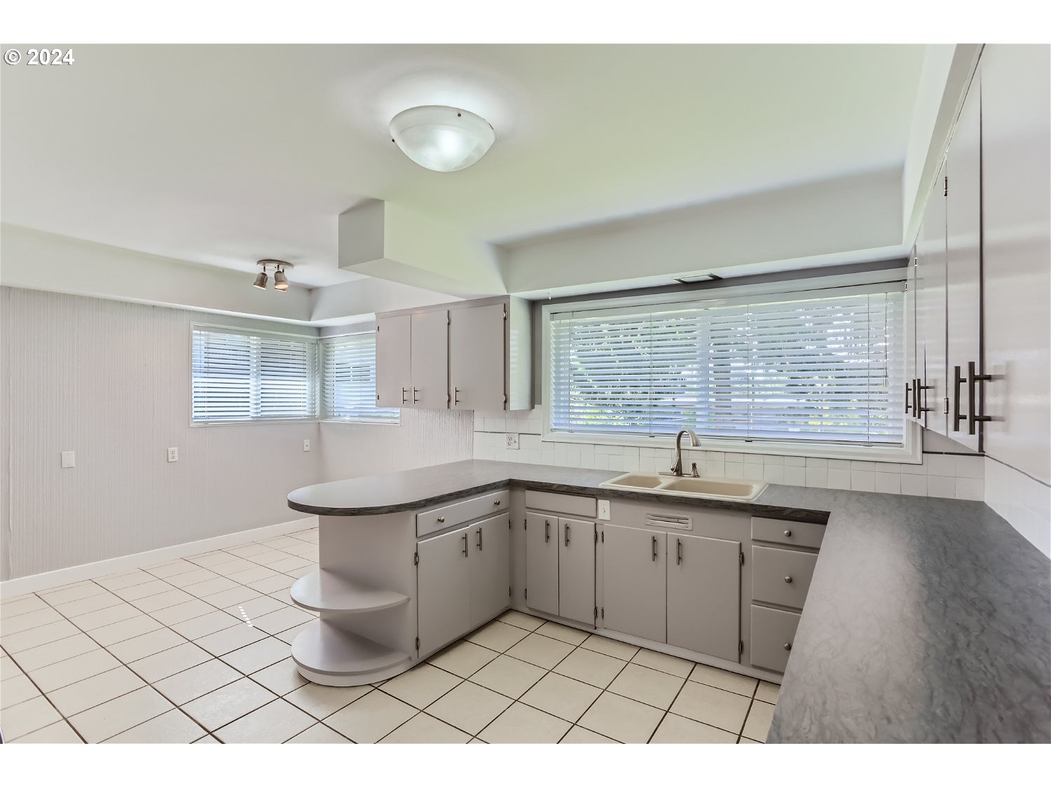 9386 Southwest 35th Avenue Portland, OR 97219 - Photo 12 of 29 a kitchen with a sink and cabinets