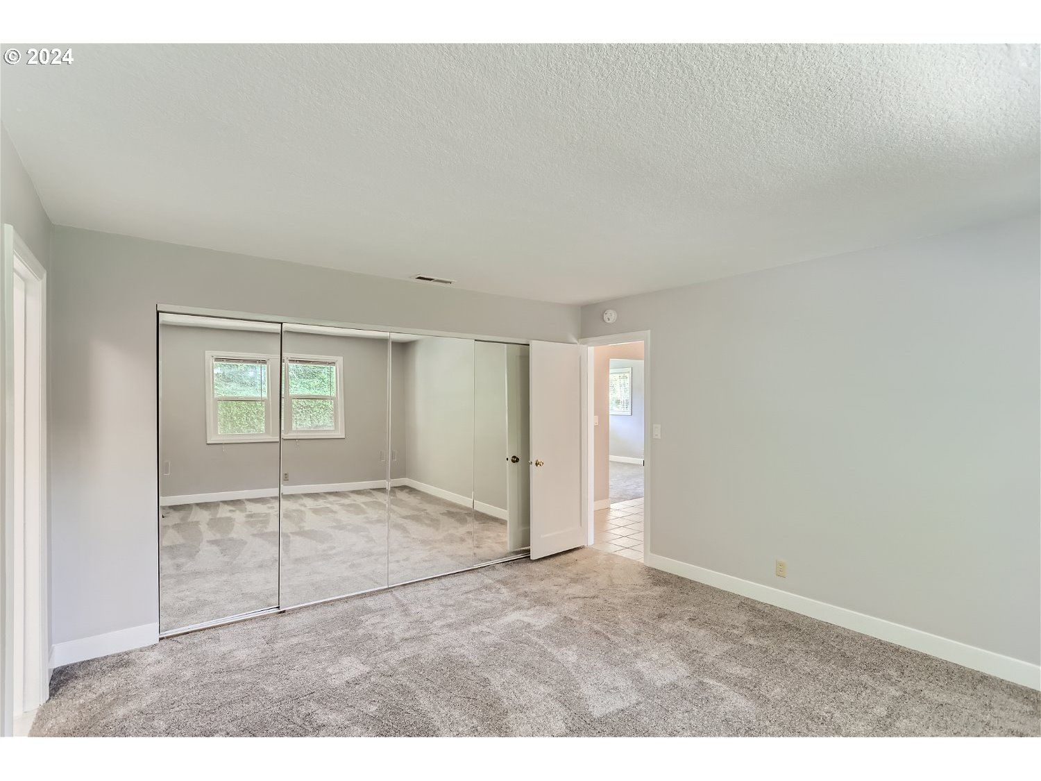 9386 Southwest 35th Avenue Portland, OR 97219 - Photo 18 of 29 an empty room with windows and closet