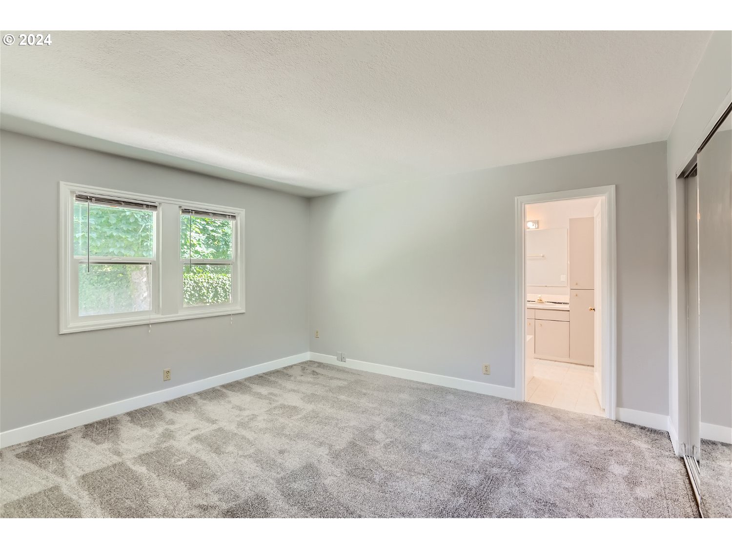 9386 Southwest 35th Avenue Portland, OR 97219 - Photo 20 of 29 a view of an empty room with a window