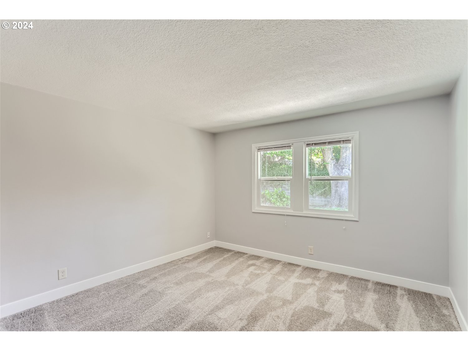9386 Southwest 35th Avenue Portland, OR 97219 - Photo 22 of 29 an empty room with wooden floor and windows