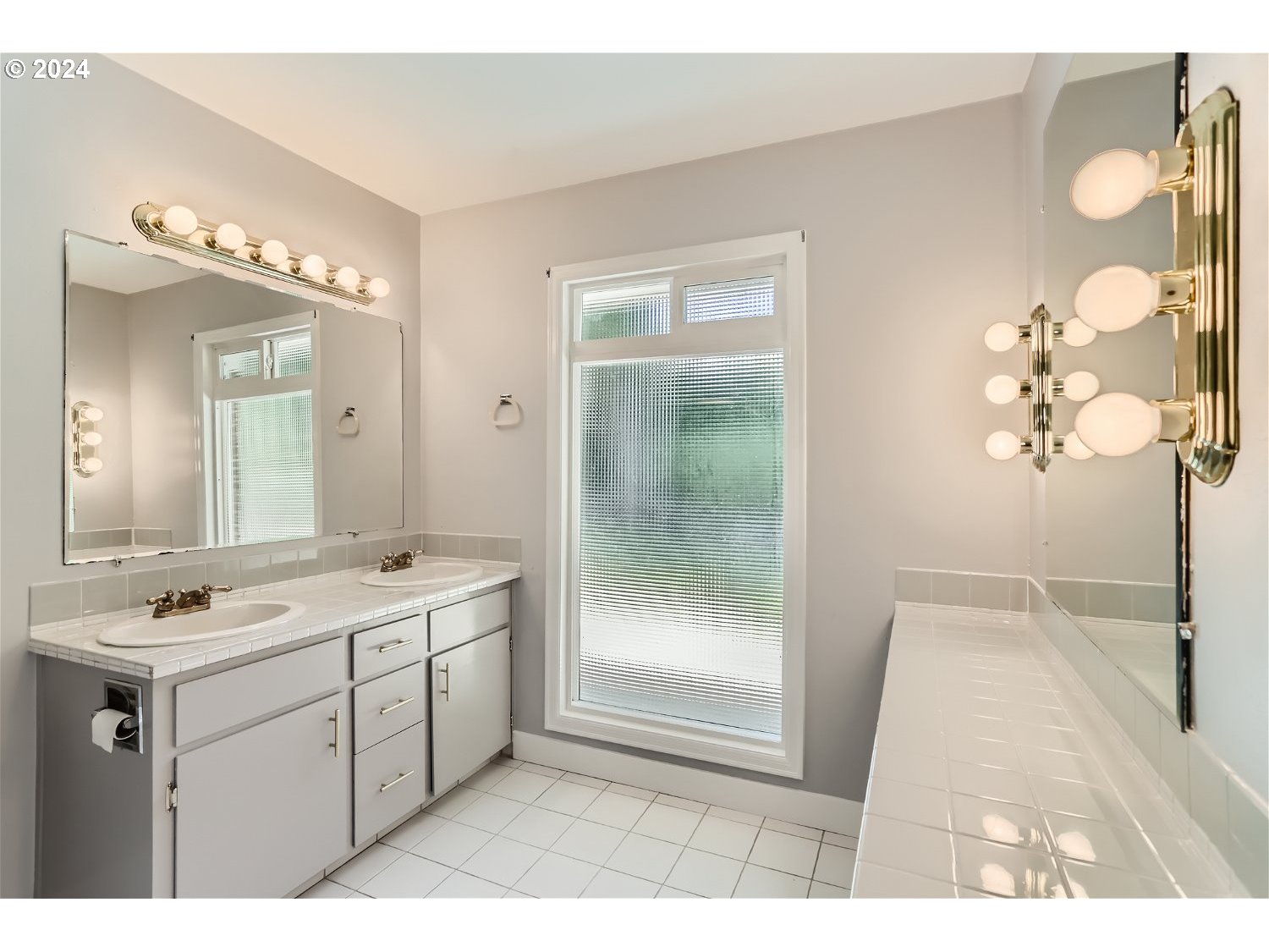 9386 Southwest 35th Avenue Portland, OR 97219 - Photo 24 of 29 a bathroom with a sink a mirror and a shower